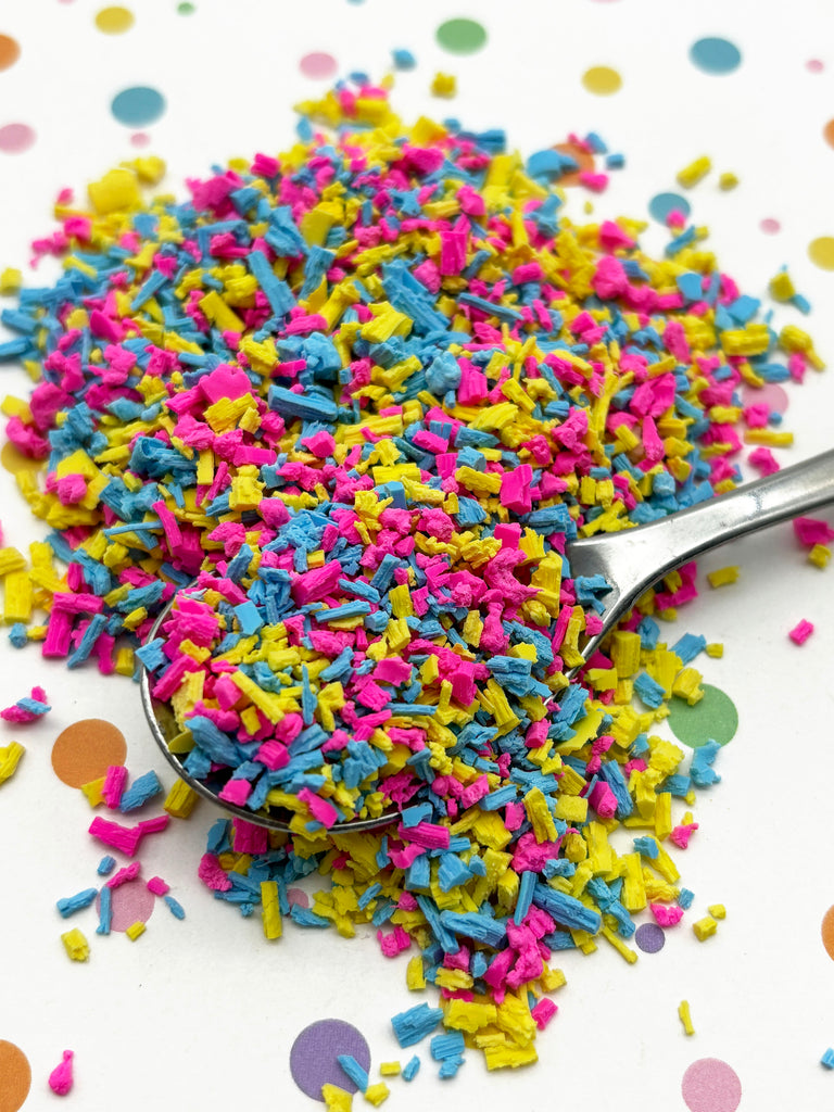 a spoon full of sprinkles on a table