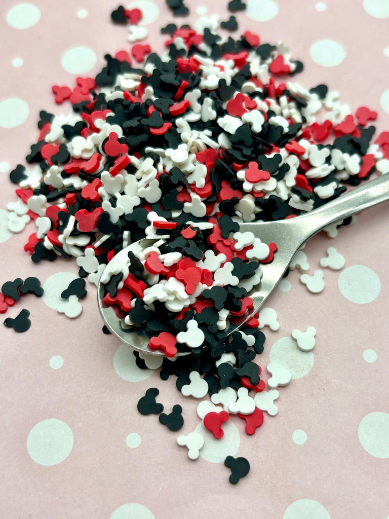 a spoon full of red, white and black confetti