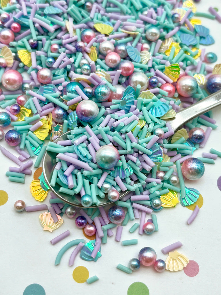 a spoon full of colorful sprinkles and pearls