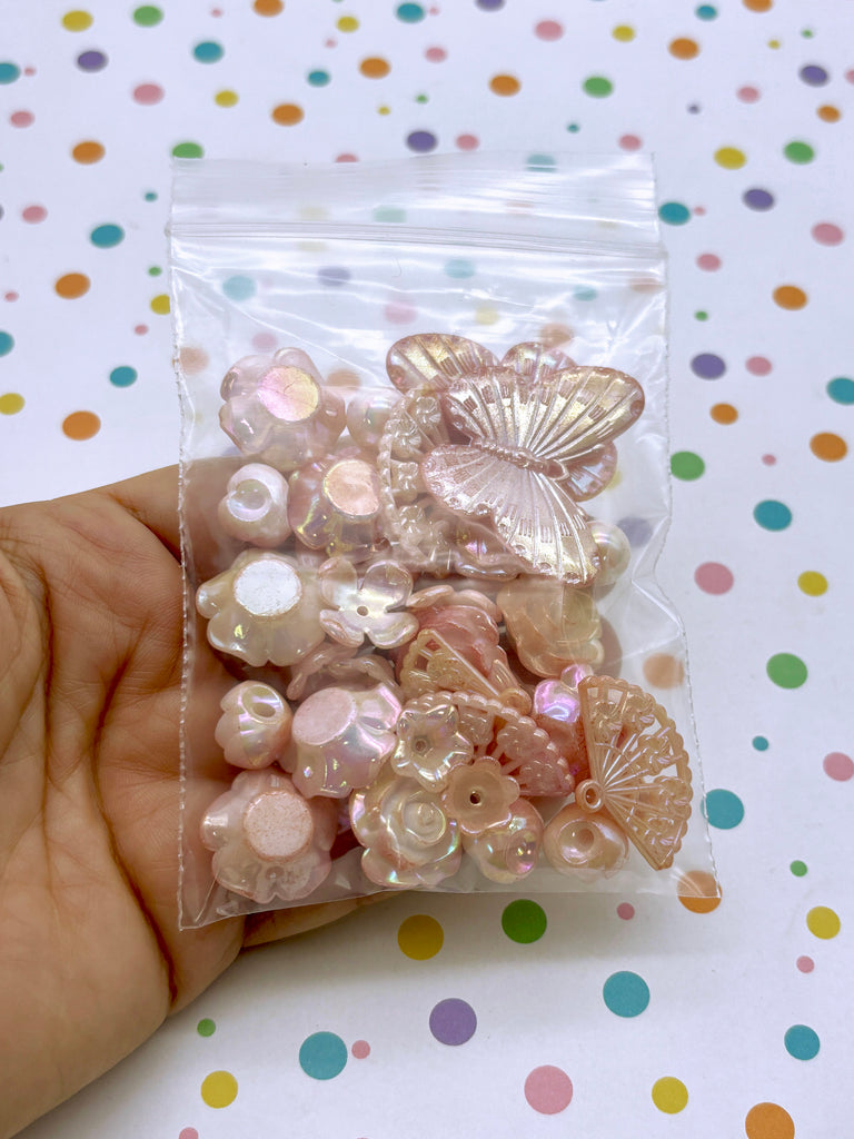 a person holding a bag of buttons in their hand