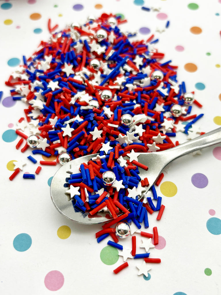 a spoon full of red, white and blue sprinkles