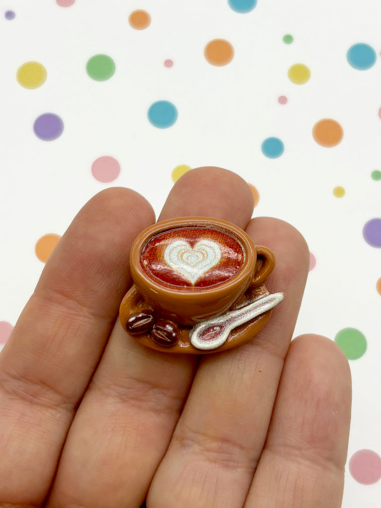 a miniature cup of coffee with a heart in it