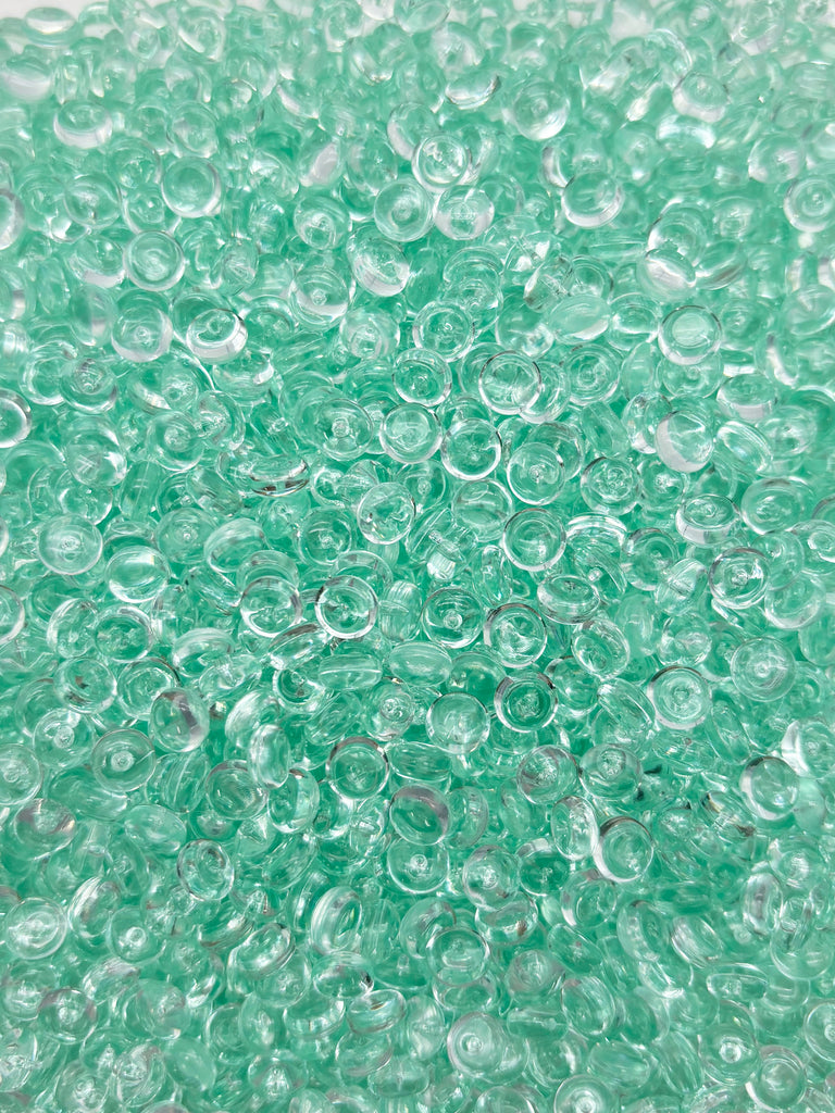 a close up of water bubbles on a white surface