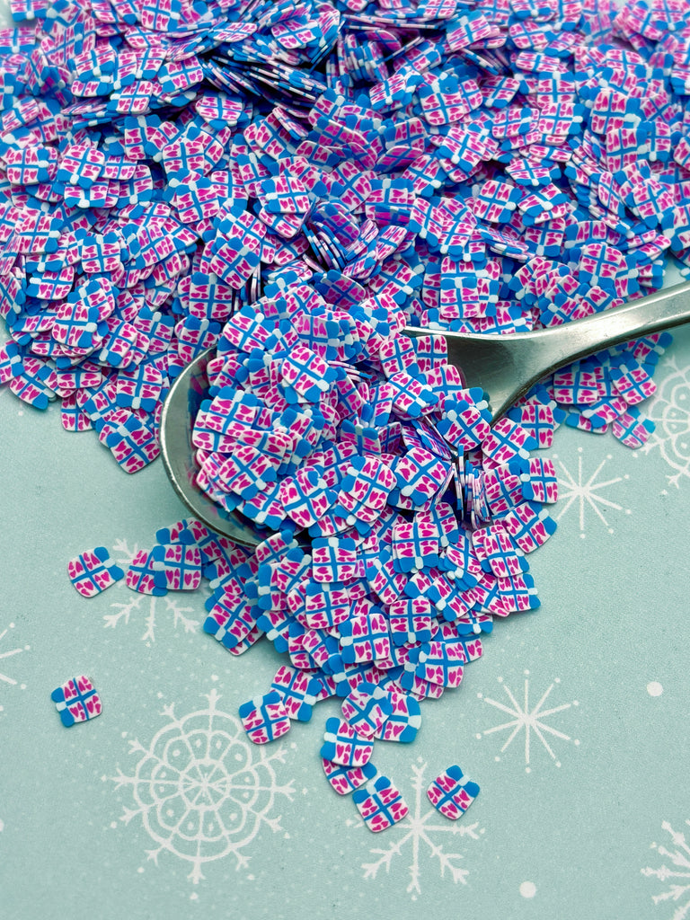 a pile of purple and blue confetti next to a spoon