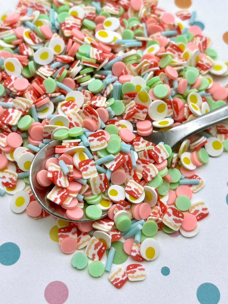 a spoon full of candy sprinkles on a table