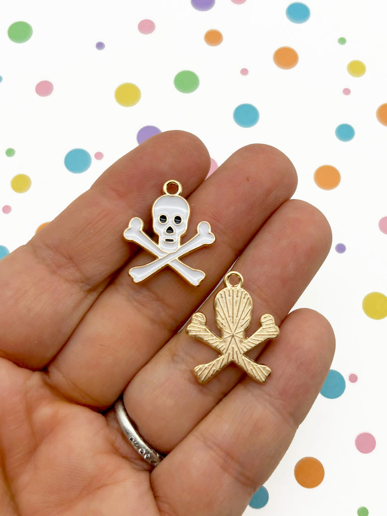 a person is holding a skull and crossbone charm