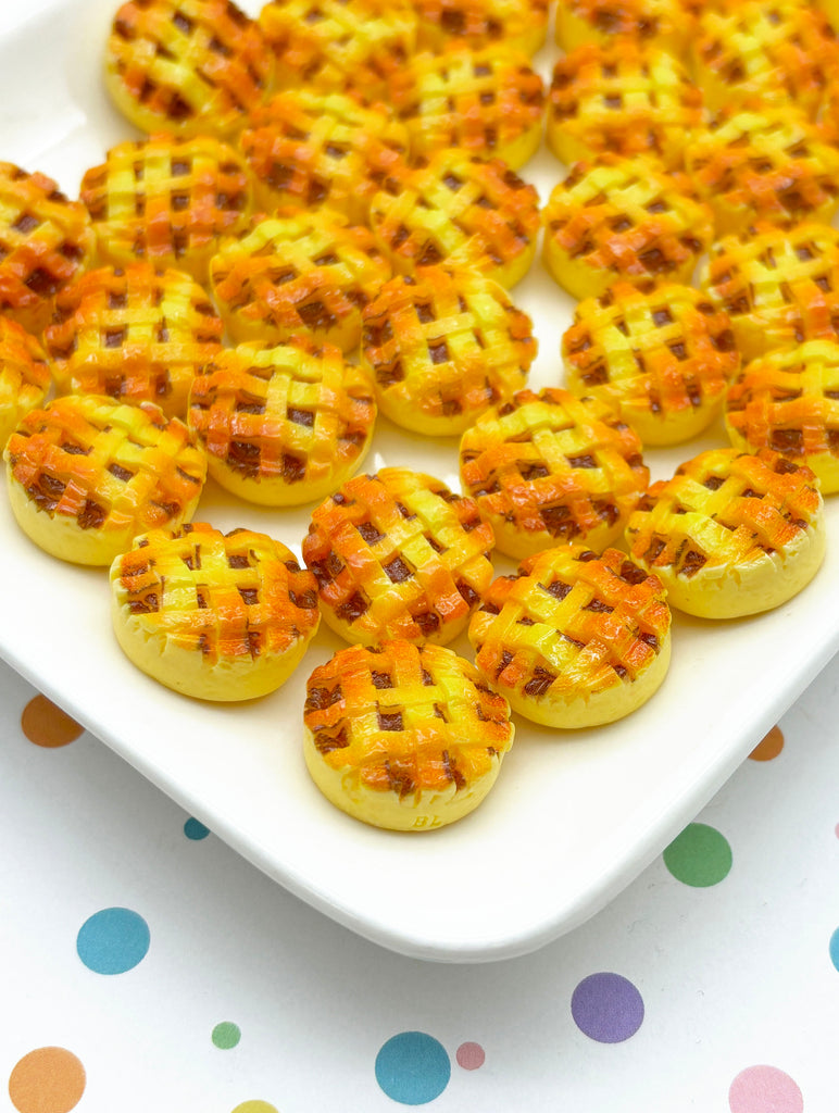 a white plate topped with mini pies on top of a table