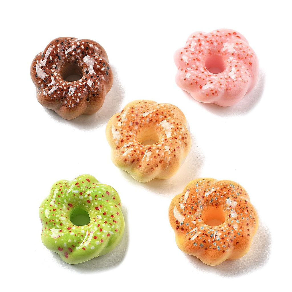 a group of four donuts sitting on top of a white table