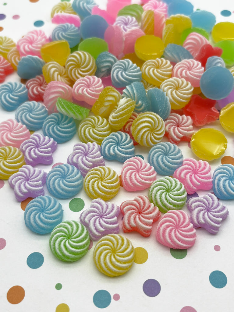 a pile of colorful lollipops sitting on top of a table