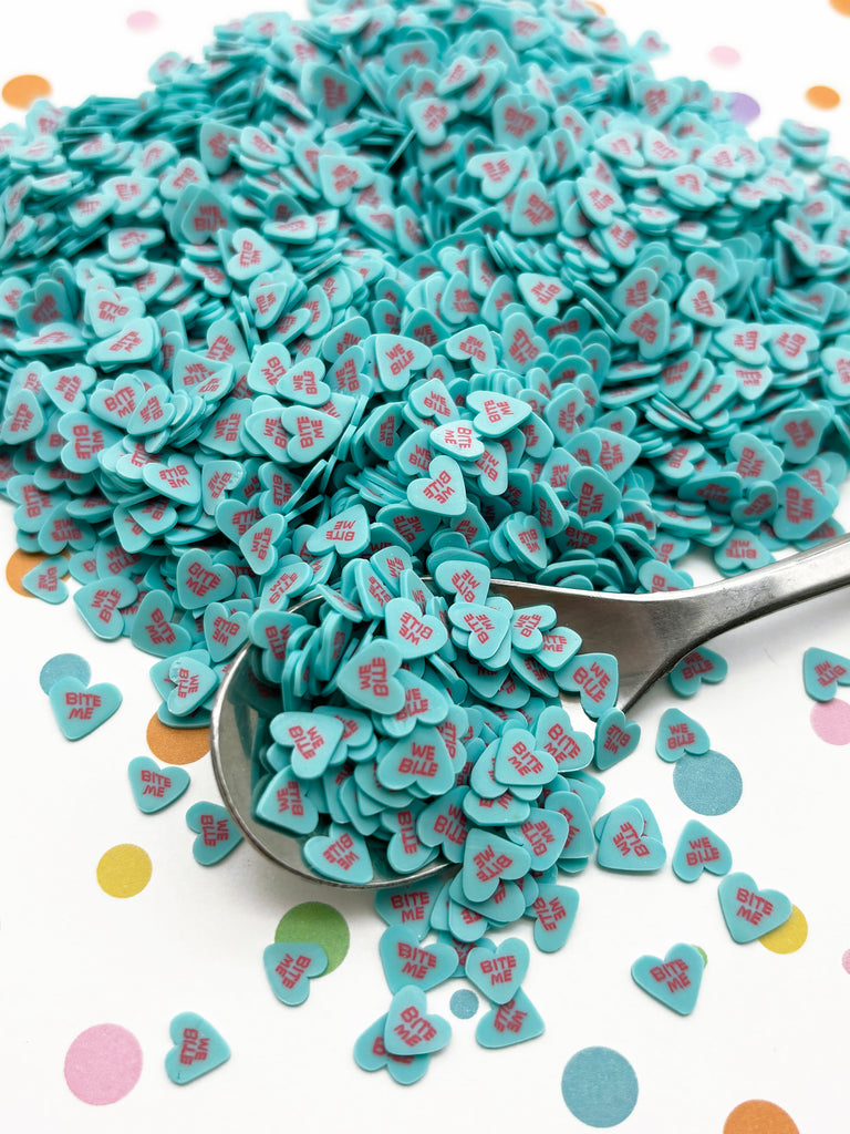 a spoon full of blue heart shaped confetti