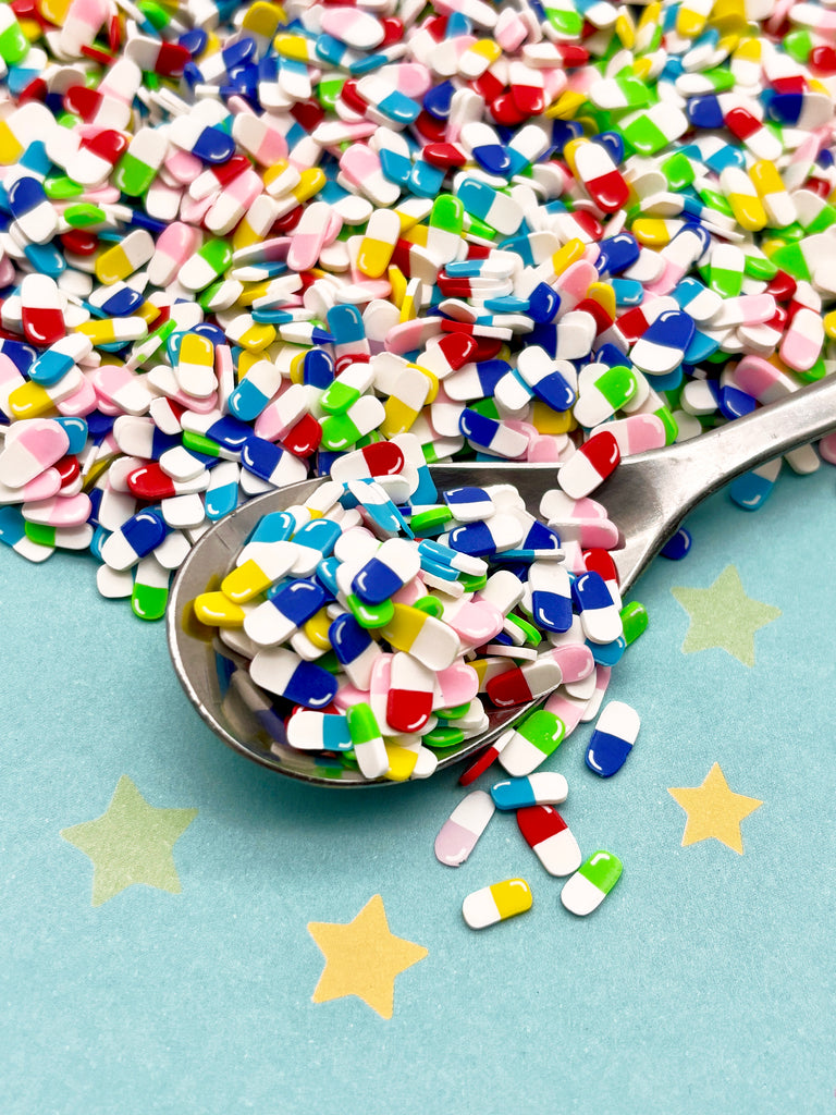 a spoon full of colorful sprinkles on a blue surface