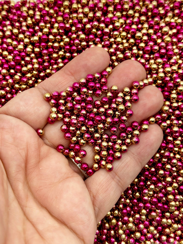 a hand holding a bunch of beads in it's palm