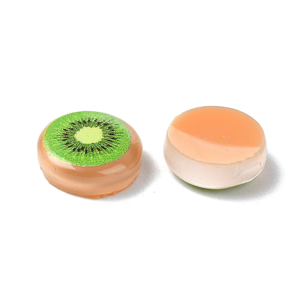 two round, orange-colored objects with a green kiwi-like design on them.