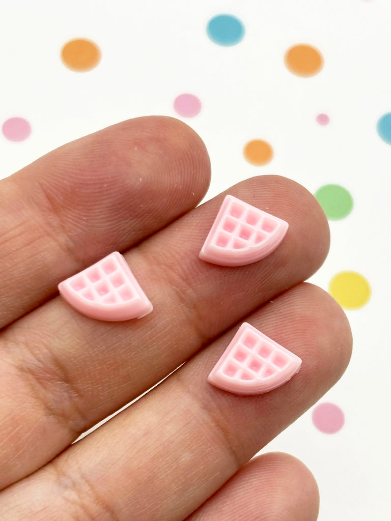 a person's hand with a pink manicure on it