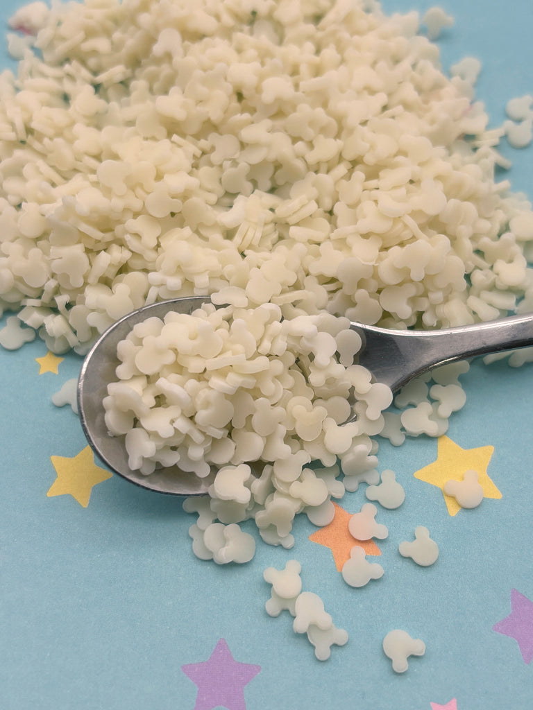 a spoon filled with white rice on top of a table