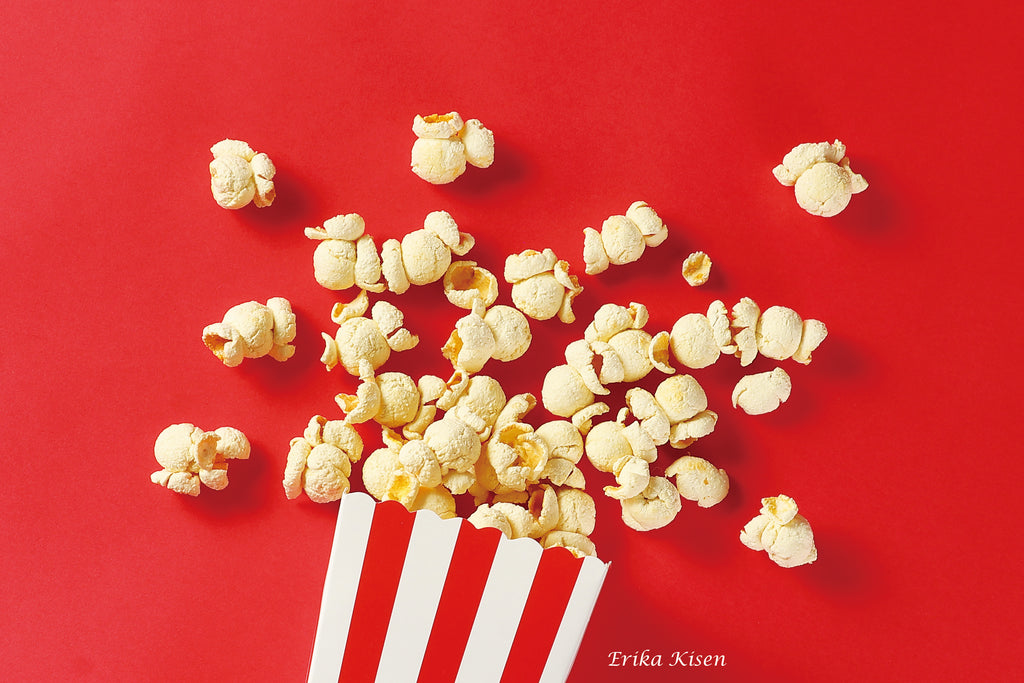 a red and white striped bag of popcorn