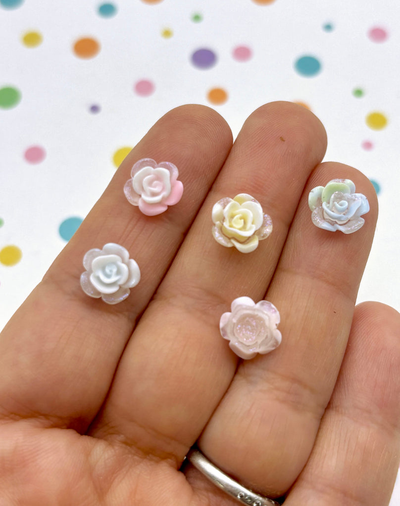 a person's hand holding a bunch of fake flowers