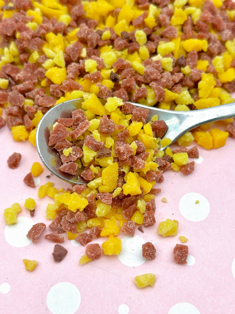 a spoon full of food sitting on top of a table