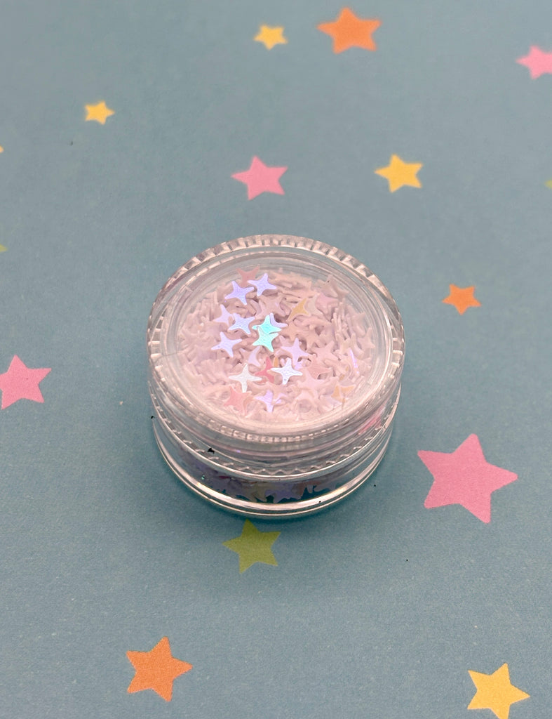 a small jar of glitter sitting on top of a table