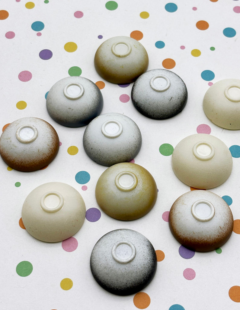 a collection of various colored bowls arranged on a surface with colorful polka dots.
