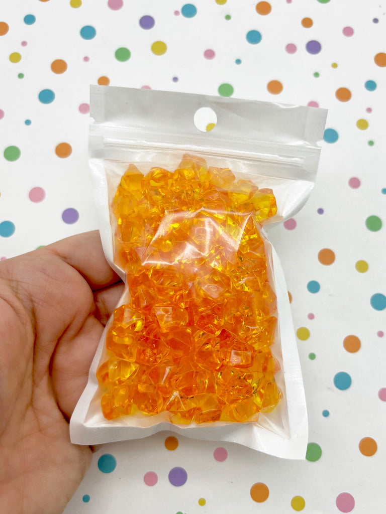 a hand holding a bag of gummy bears