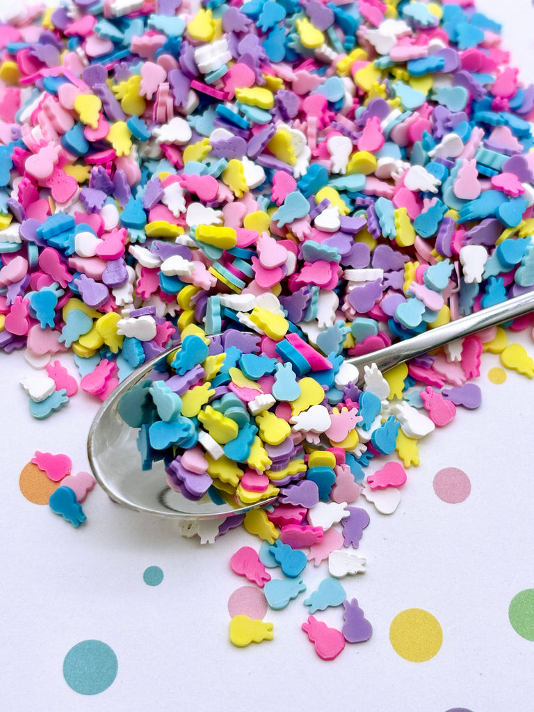 a spoon full of confetti sprinkles on a table