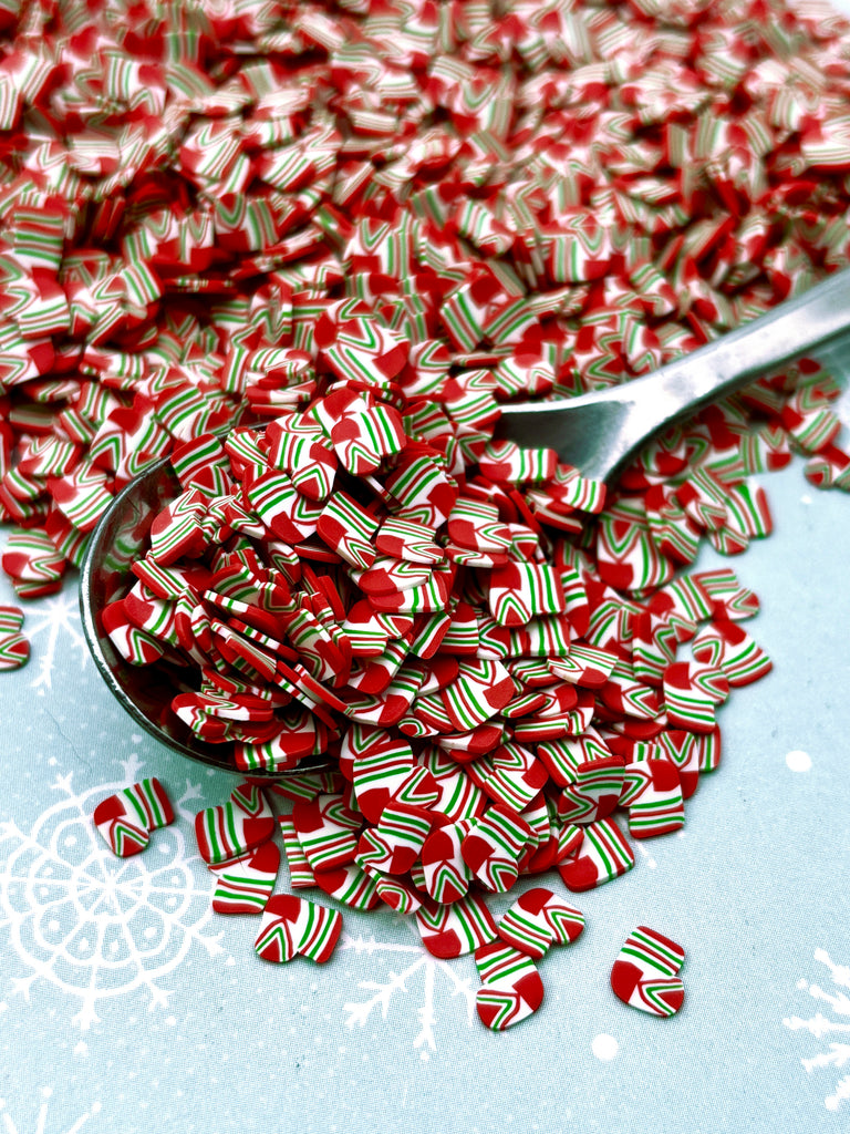 a spoon full of candy canes on a table