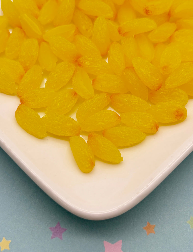 a close up of a plate of yellow candies