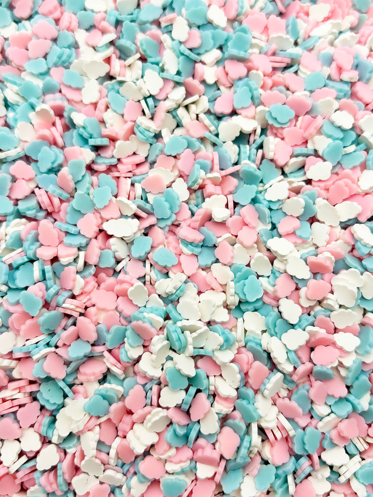 a pile of pink and blue sprinkles sitting on top of a table