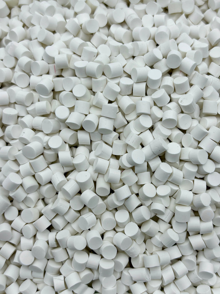 a close up of a pile of white pills