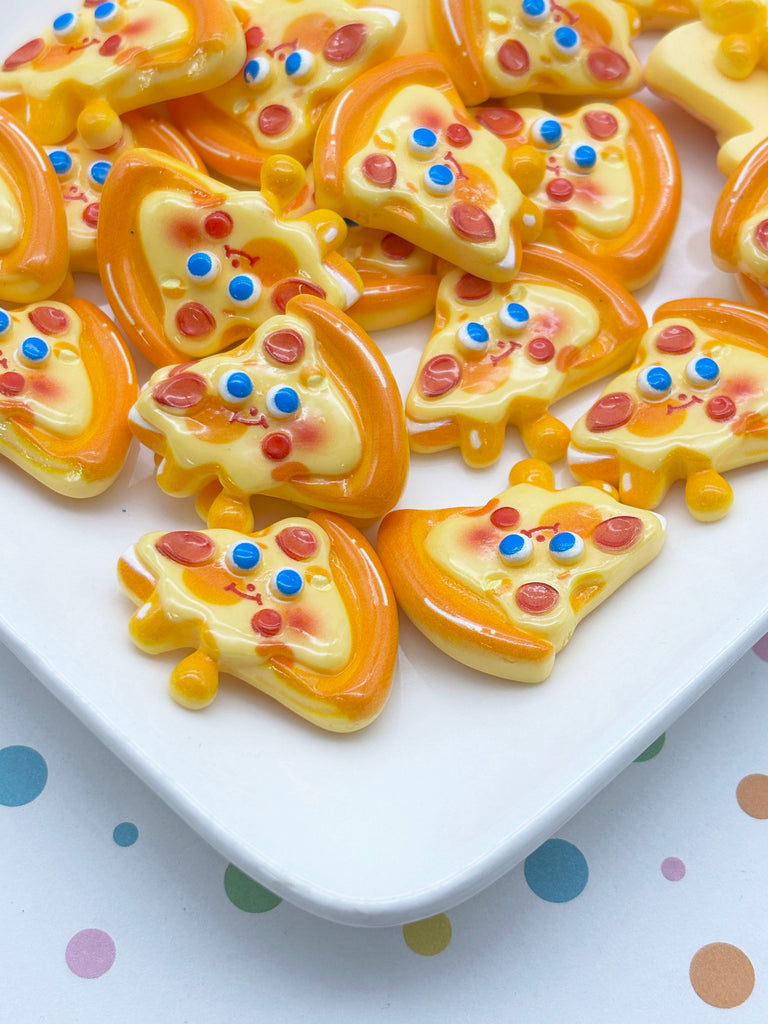 a white plate with a variety of colorful, candy-like pizza slices arranged on it.