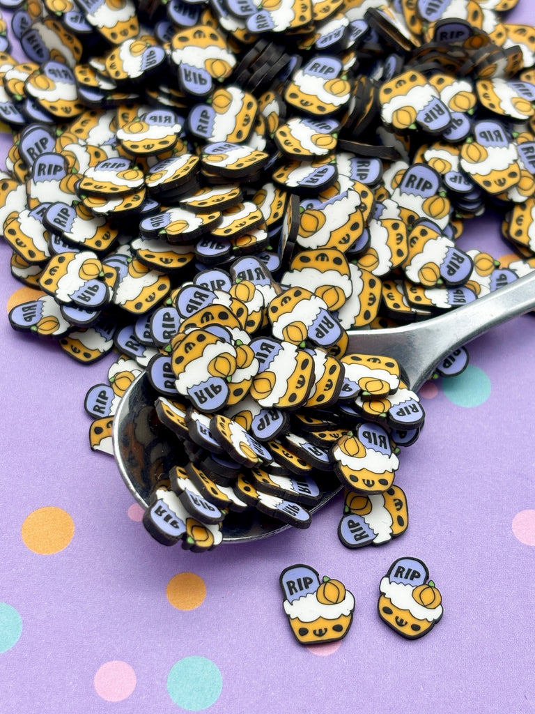 a spoon full of gold and white buttons on a purple background