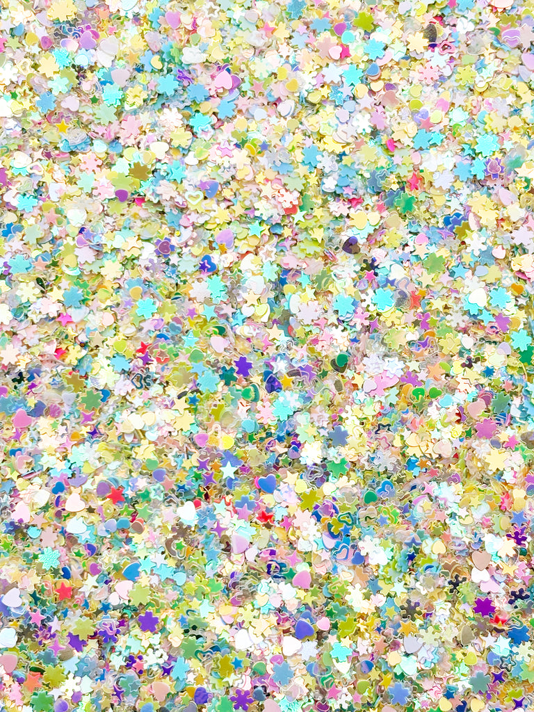 The image is a collage of various colorful shapes and patterns, including stars, hearts, and flowers, creating a vibrant and visually striking composition.