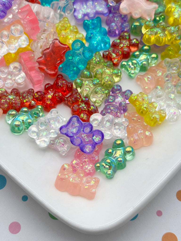 A plate filled with a variety of colorful gummy bear candies in different shapes and sizes.