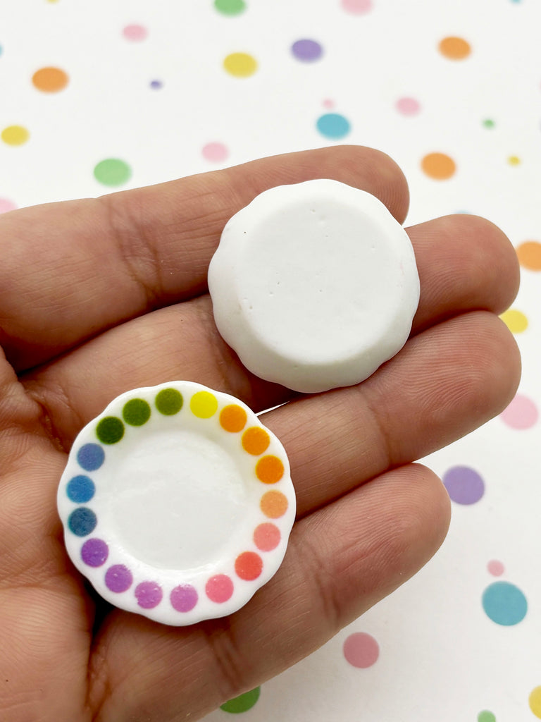 a person holding a small white button in their hand