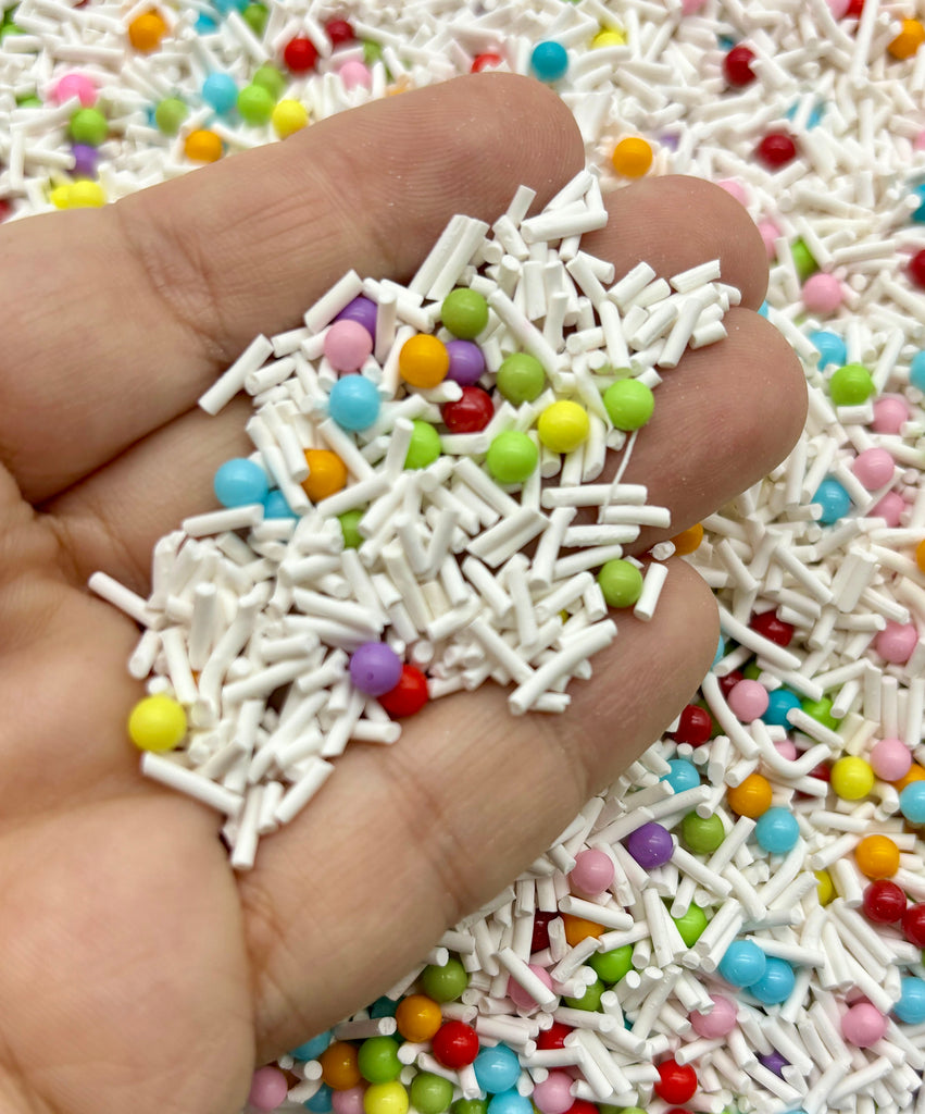 a hand is holding a pile of sprinkles