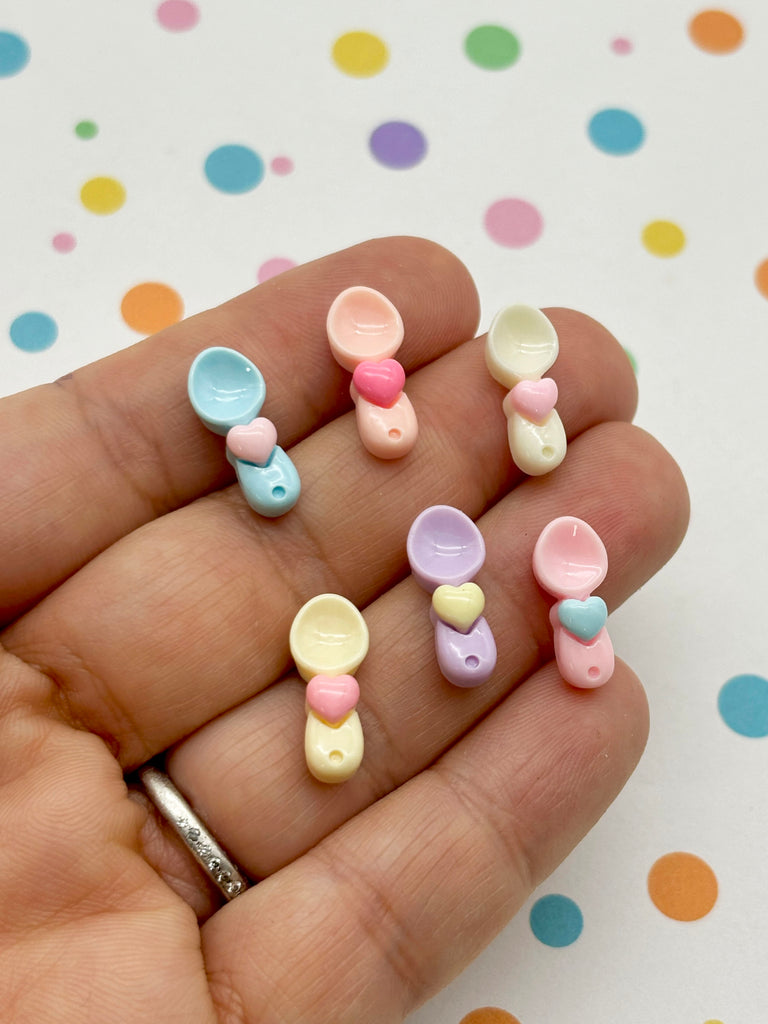 a person is holding a small set of baby pacifiers