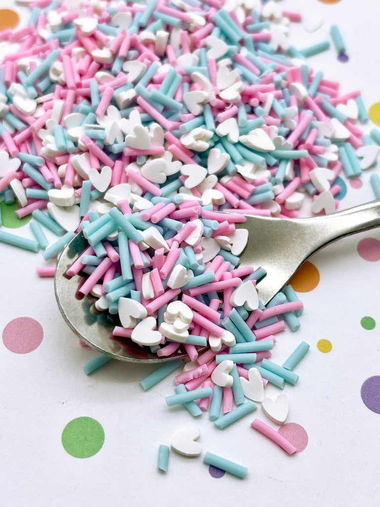 a spoon filled with sprinkles on top of a table