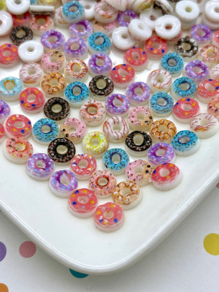 a white plate topped with lots of colorful donuts