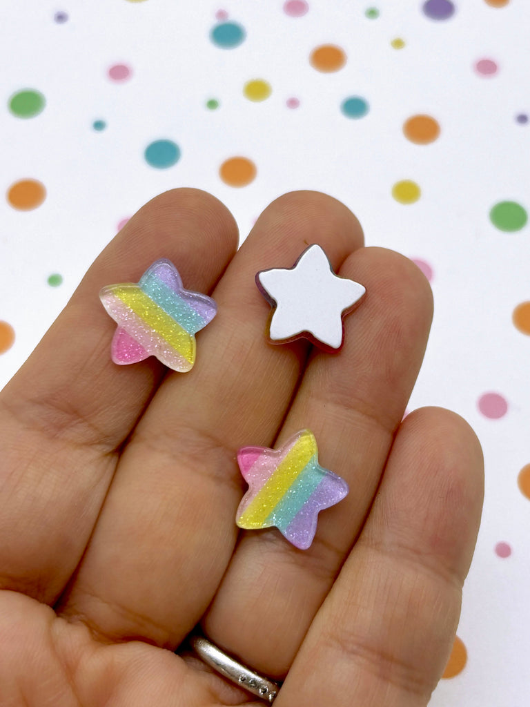 a person holding two small stars in their hand