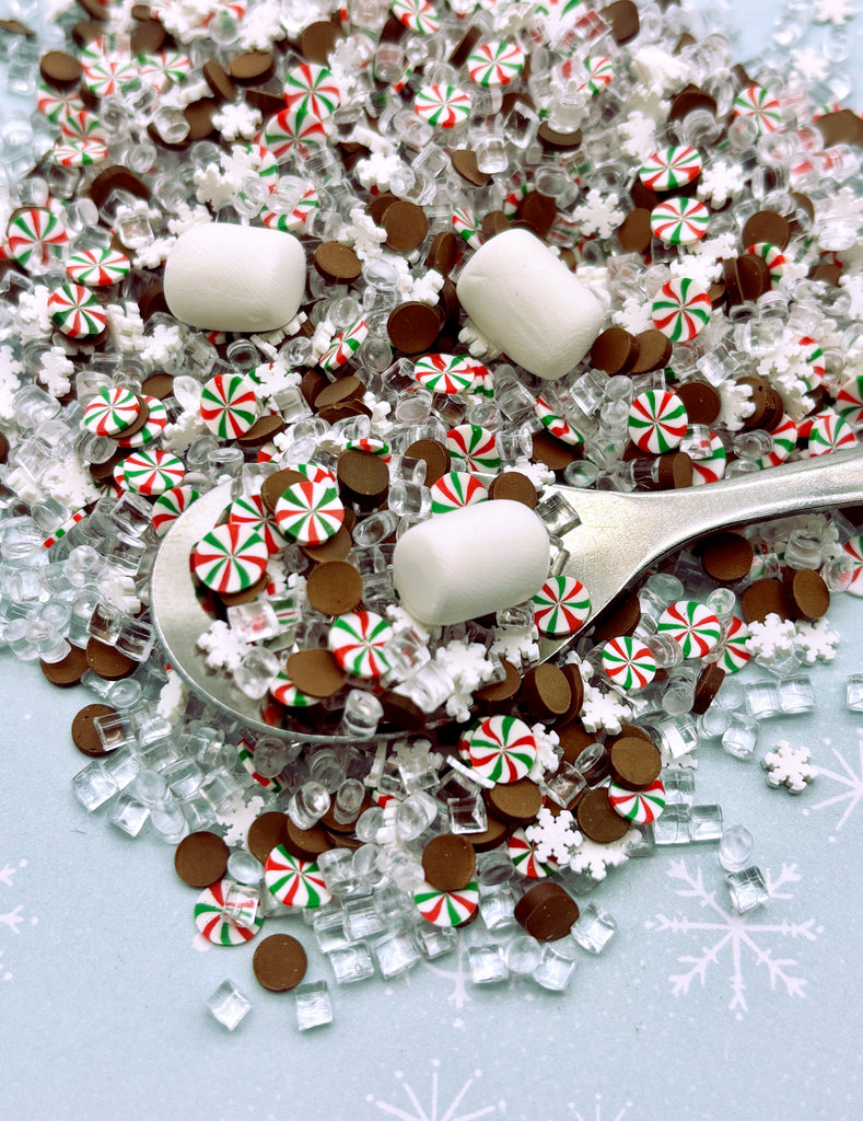 a spoon full of candy canes and snowflakes