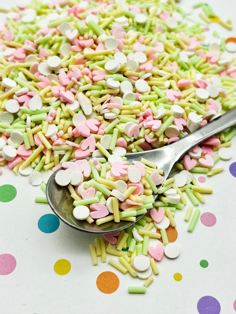 a spoon full of sprinkles on a table