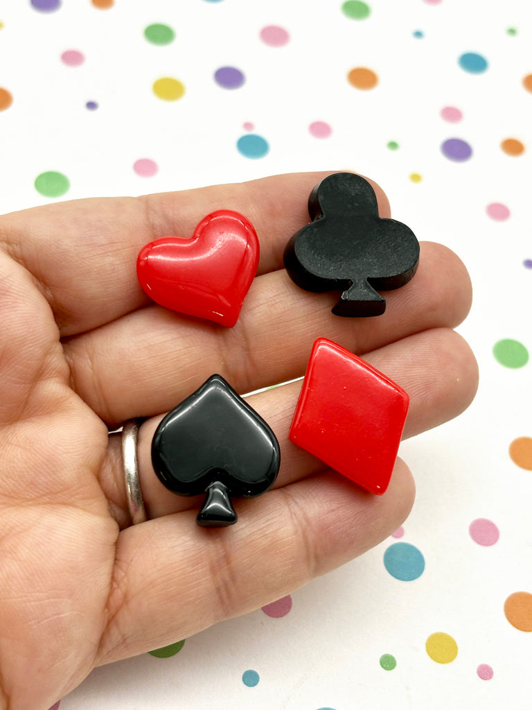 a person holding three different colored playing cards