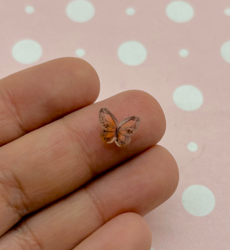 a person's hand with a tiny butterfly on it