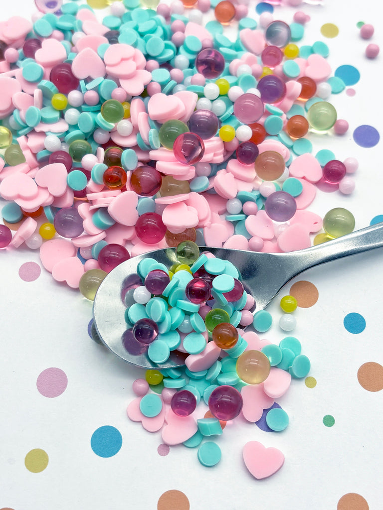 a spoon full of candy sprinkles on a table