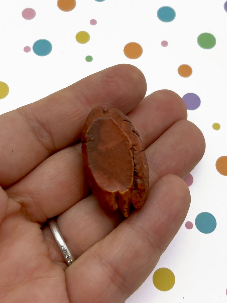 a person holding a piece of fruit in their hand