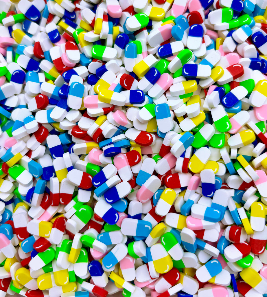 a pile of colorful pills sitting next to each other