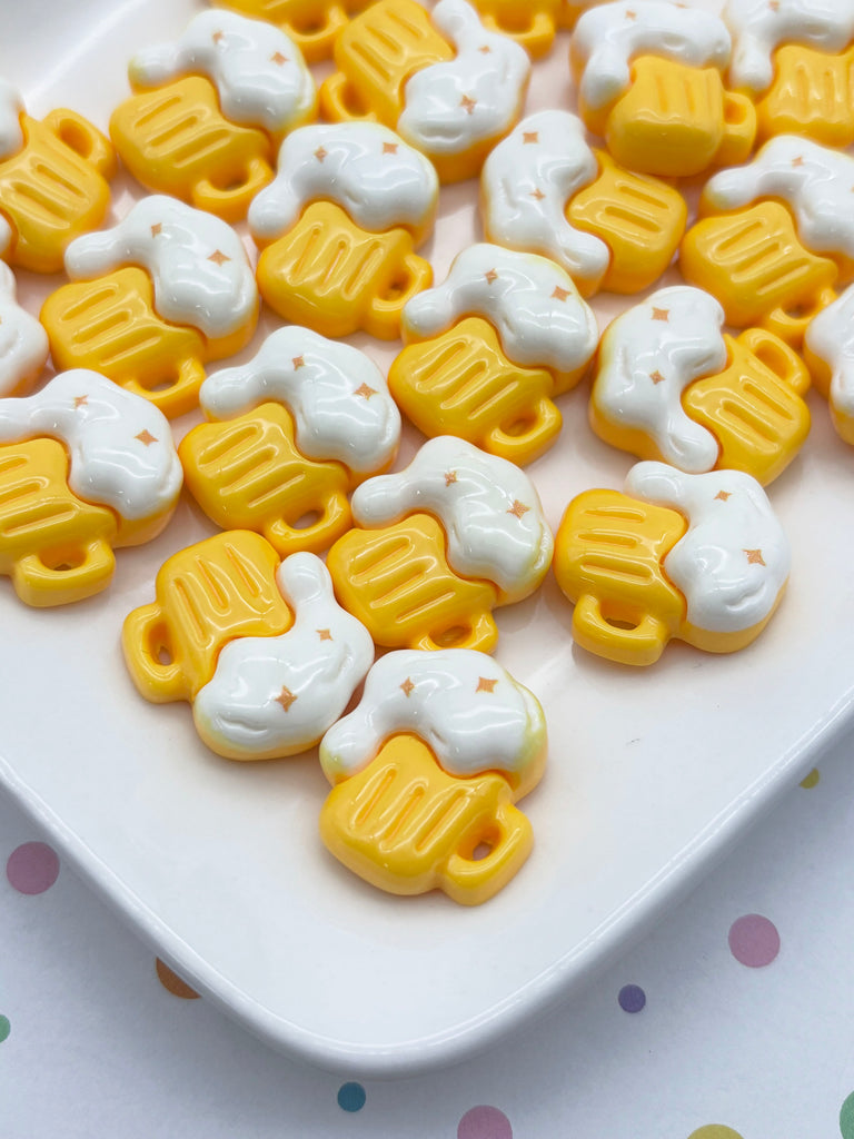 a white plate with numerous yellow and white plastic beer mug-shaped objects arranged on it.