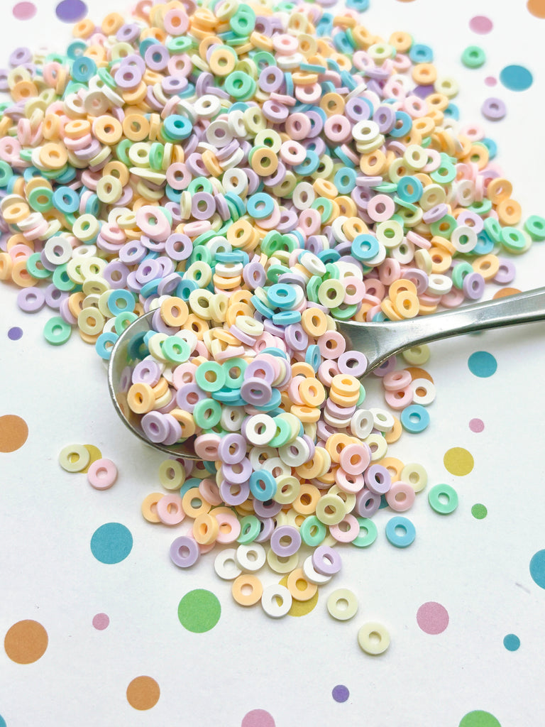 a spoon filled with lots of colorful beads