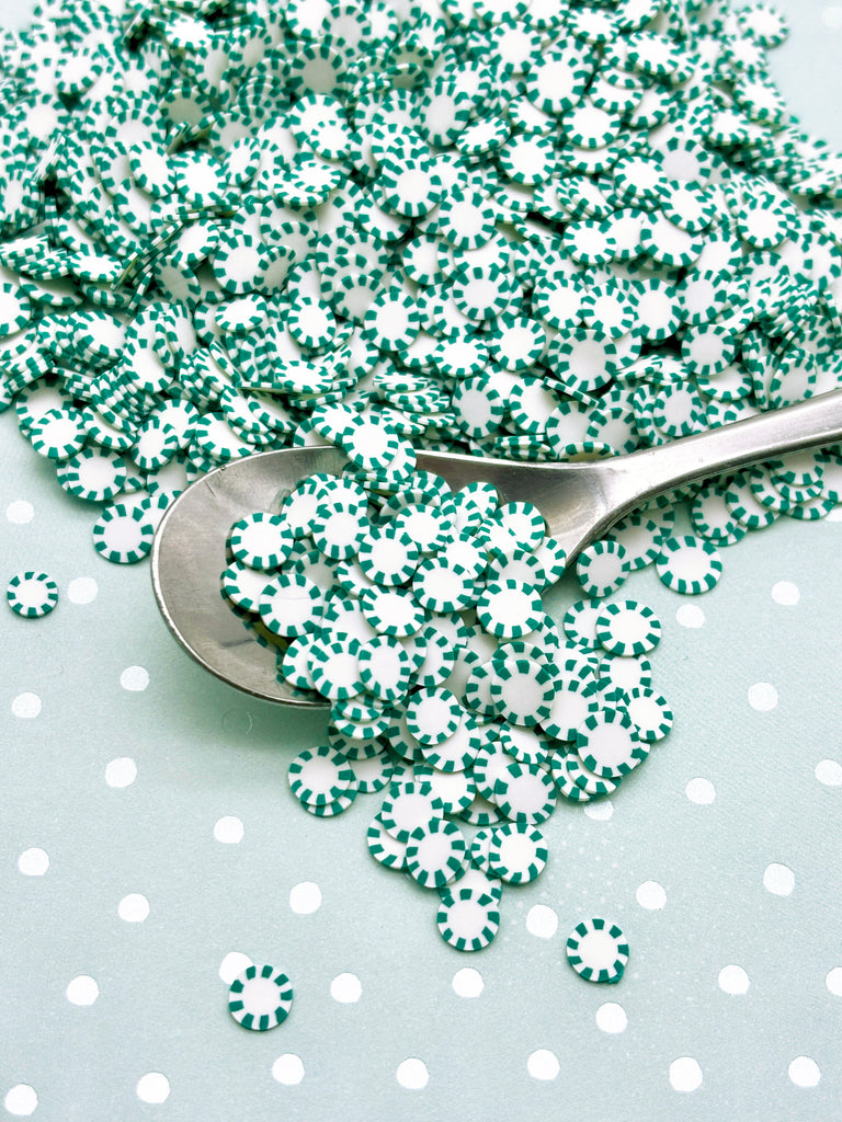 a spoon with green and white sprinkles on it